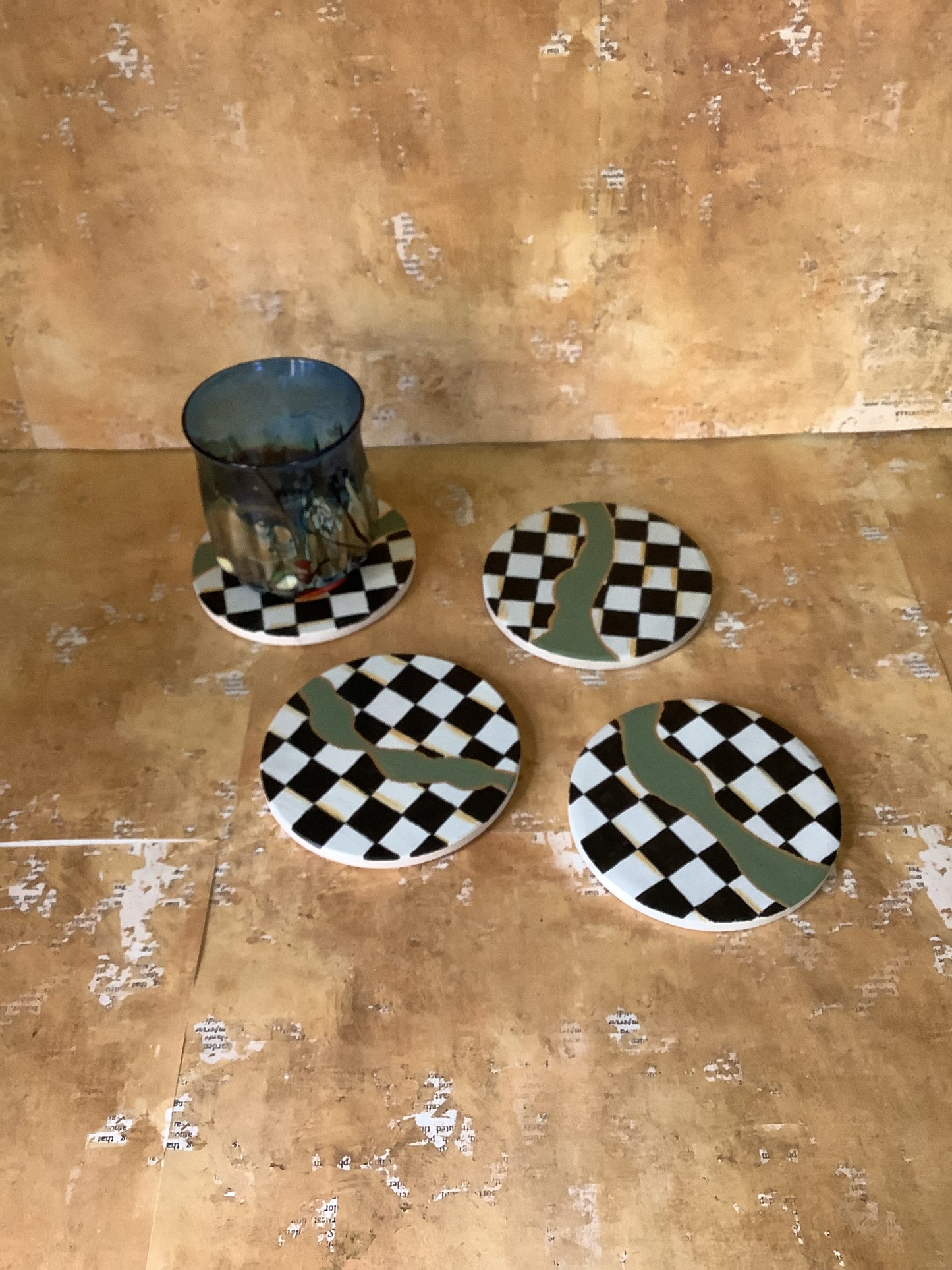 Checkered coasters with green and gold accents