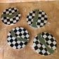 Checkered coasters with green and gold accents