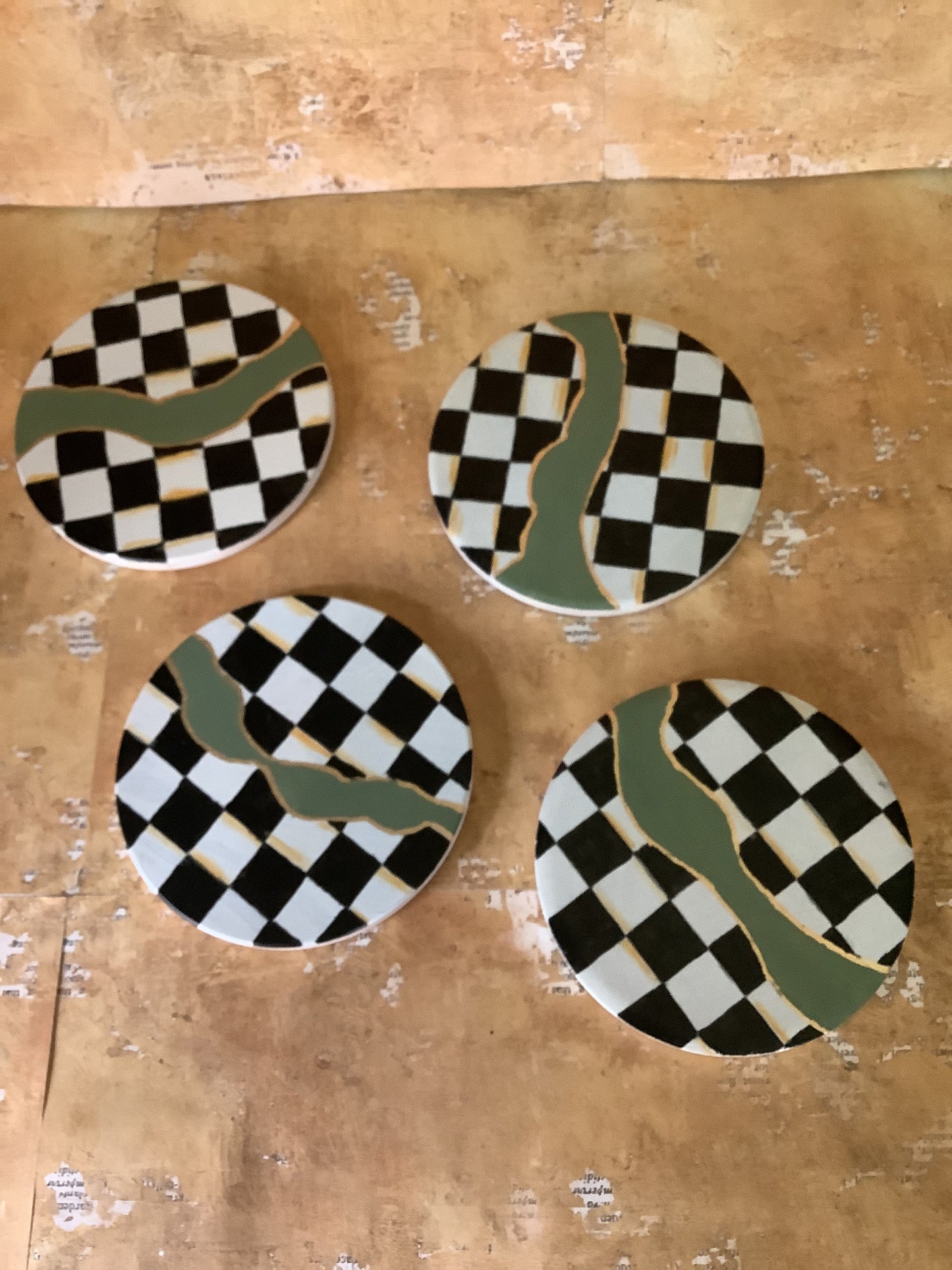 Checkered coasters with green and gold accents